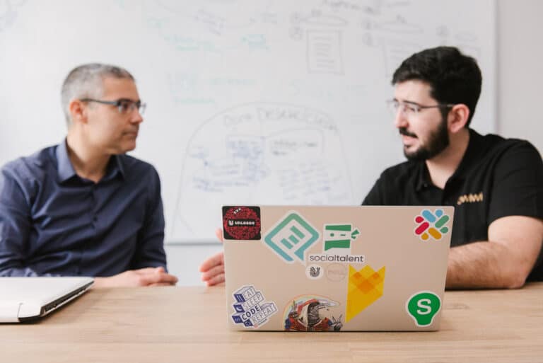 Two colleagues working at a laptop